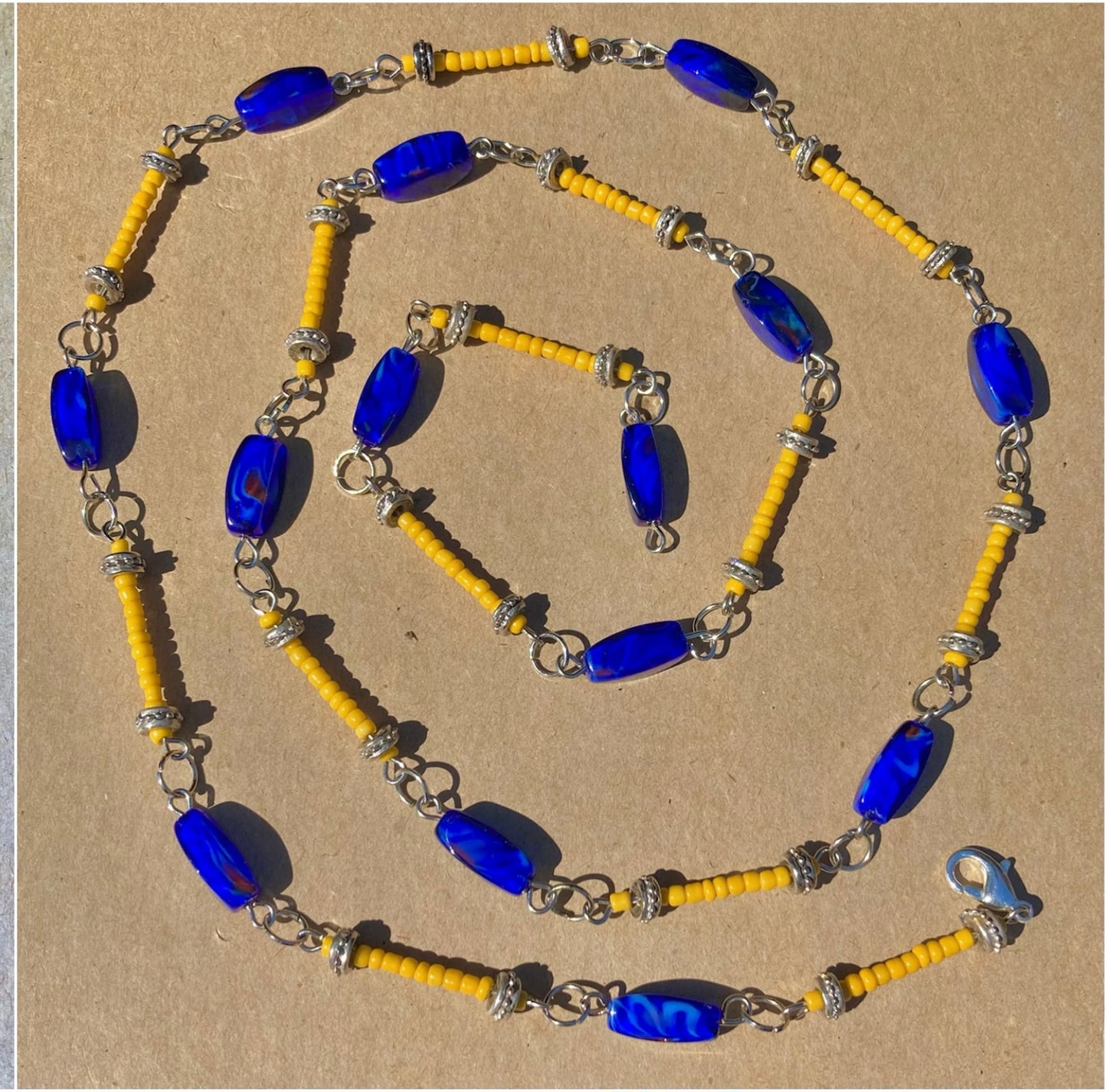 Long beaded necklace in rich blue and golden yellow