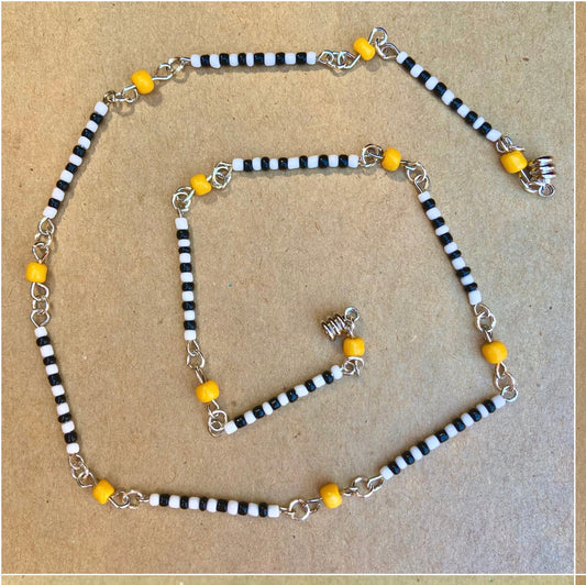 Short beaded necklace with black and white stripes with yellow spacer beads